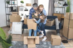 Smiling Family with boxes happy about moving tips